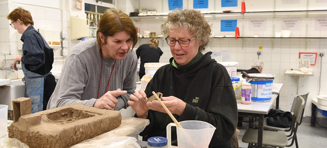 Adult Education tutor and students in a ceramics class