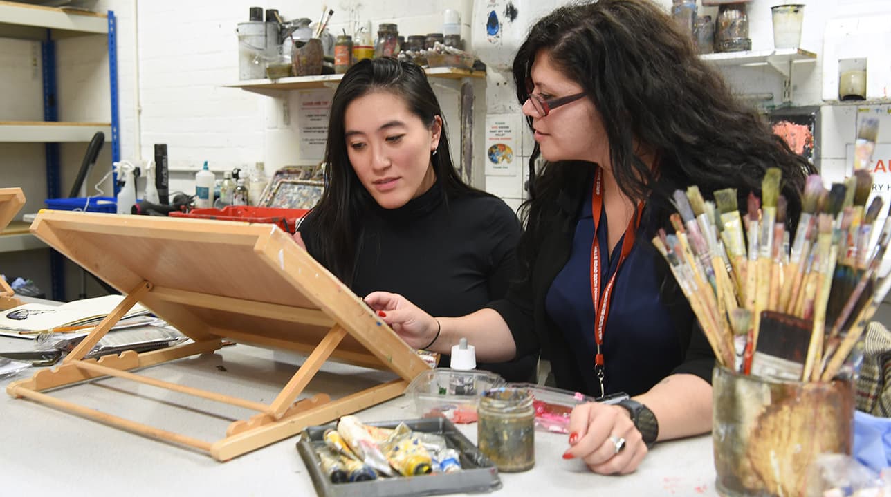 Adult Education tutor and student in a painting class