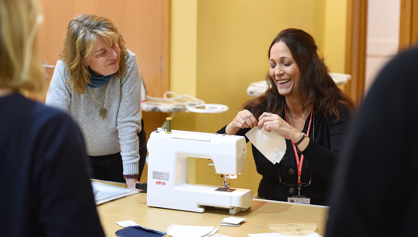 Adult Education tutor and students in a sewing class
