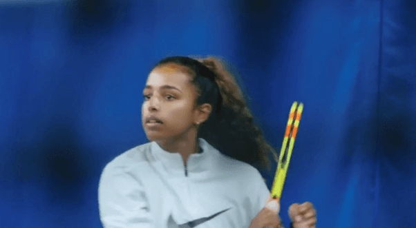 Student playing tennis