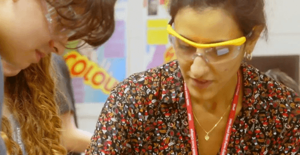 Teacher and student conducting an experiment