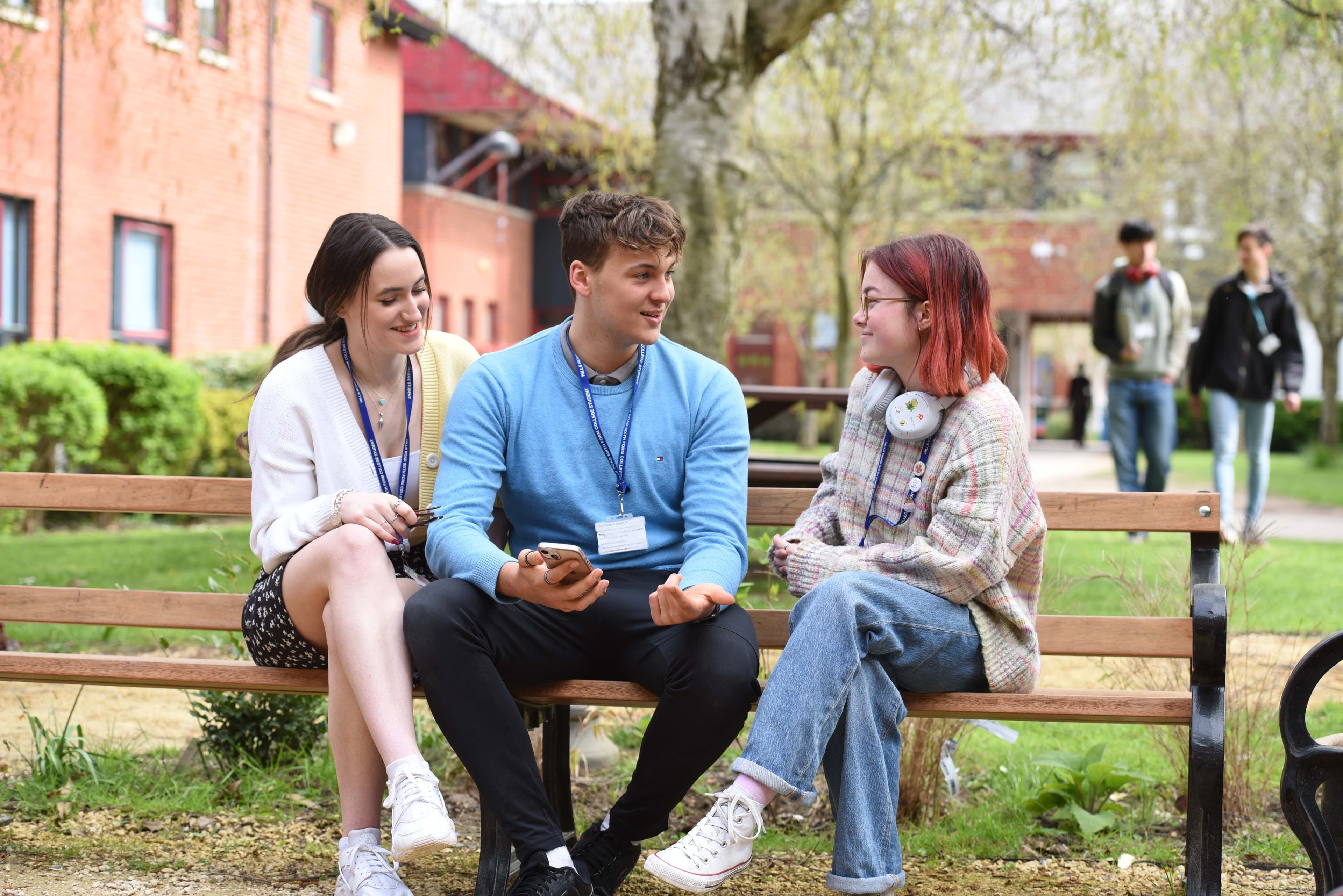 Students chatting on a bench