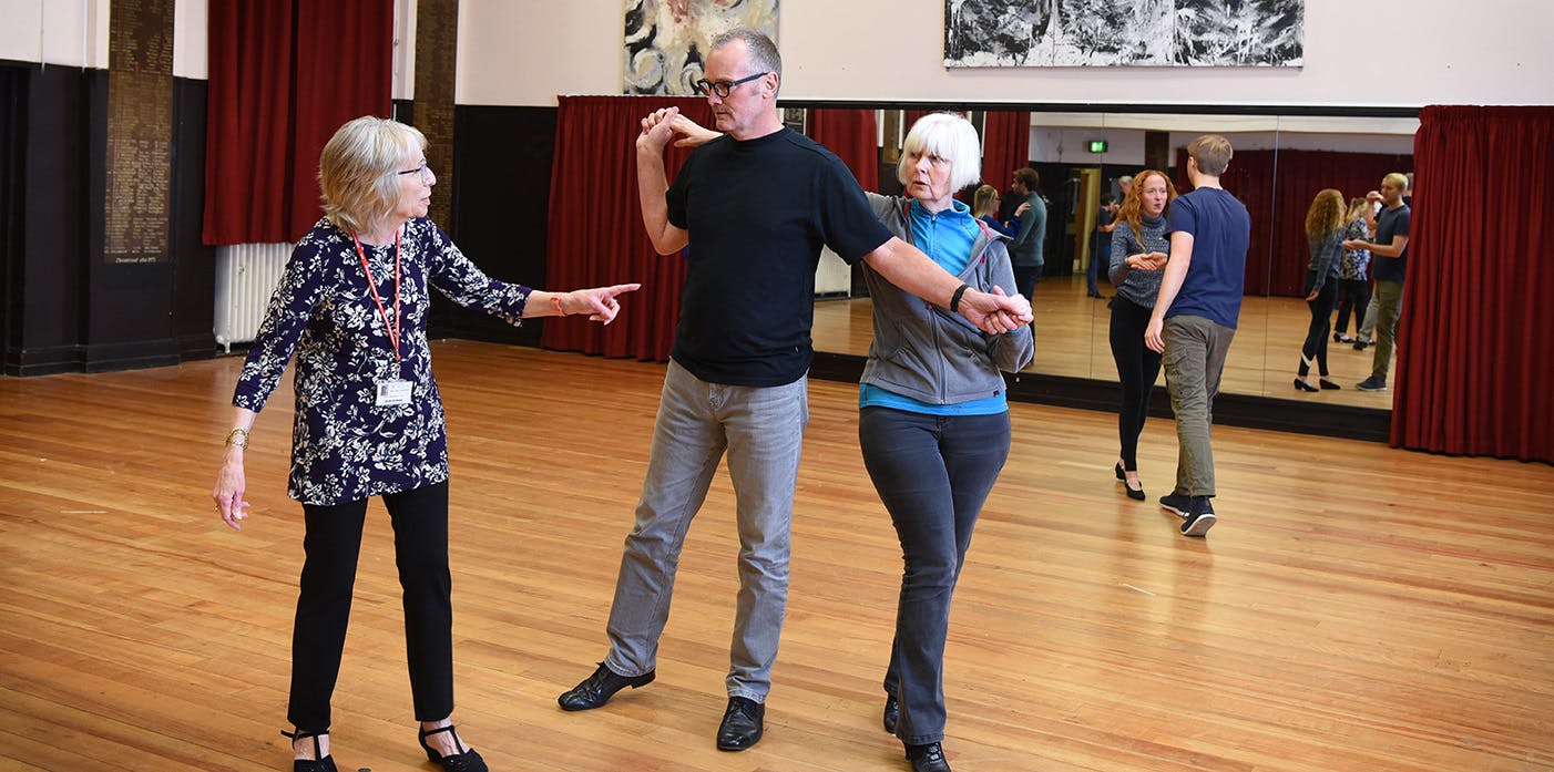 Adult Education tutor teaching students in a dance class