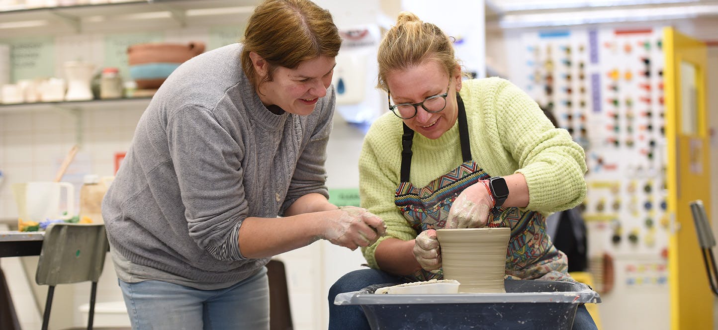Adult Education tutor and student in a ceramics class