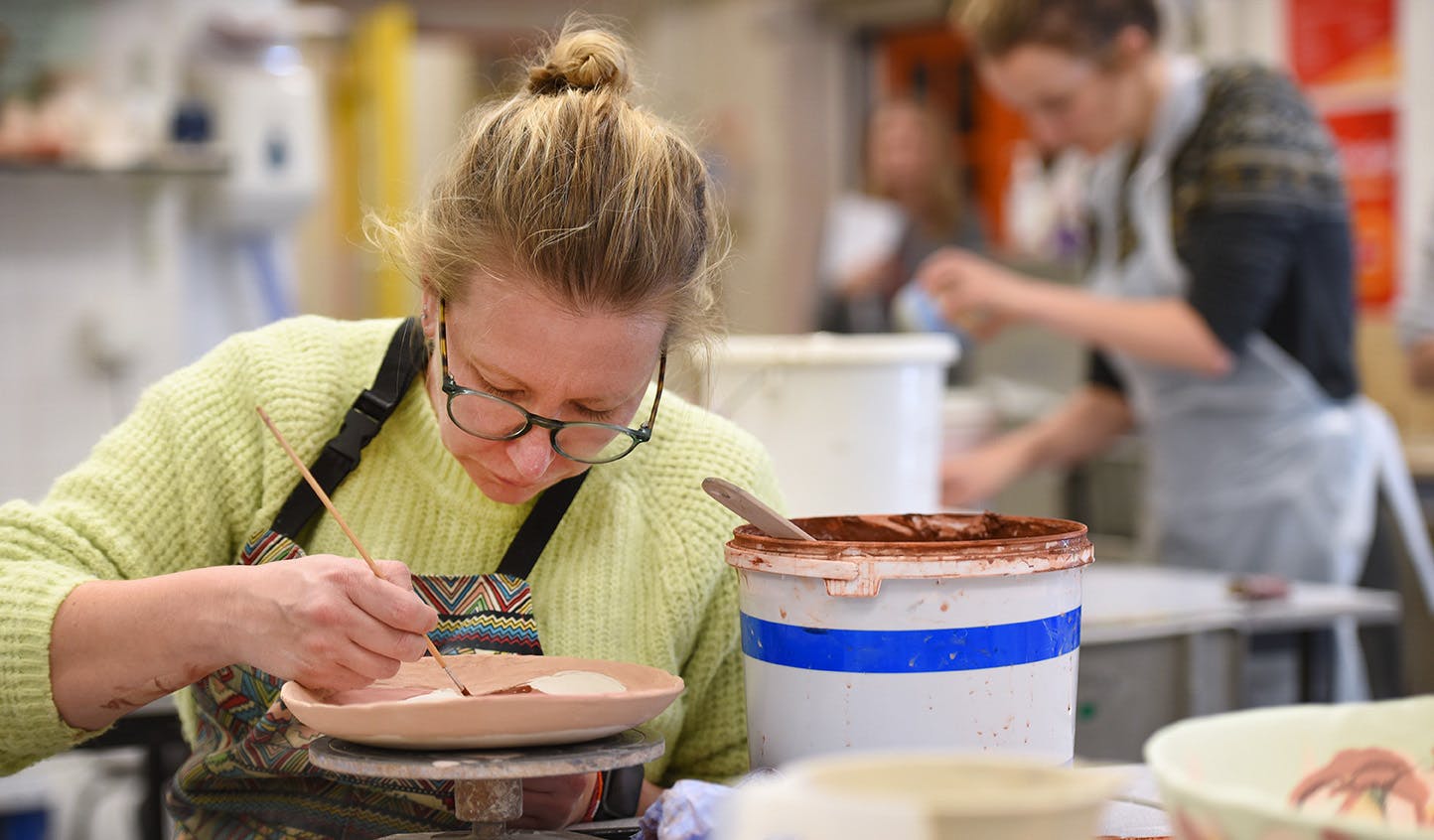 Adult Education students working in a ceramics class
