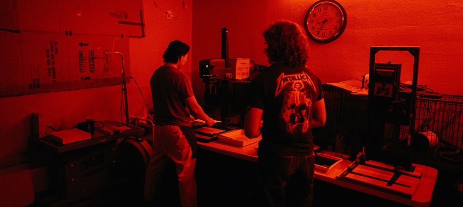 two people in a photography darkroom