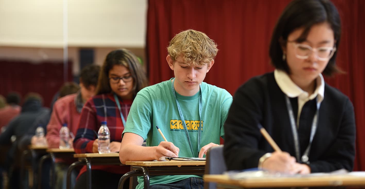 Students sitting in a row taking an exam