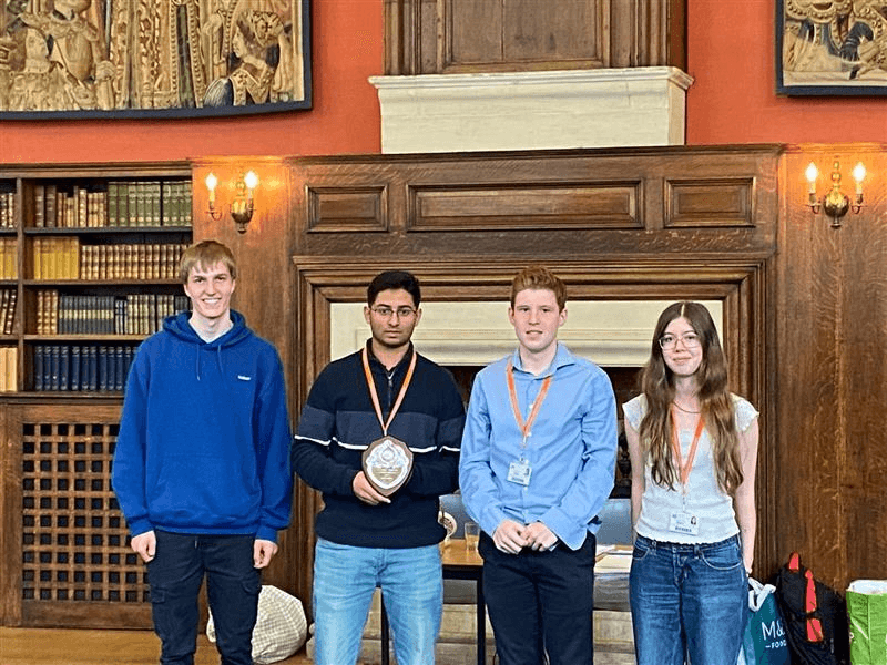 Hills University Challenge Society members with their shield