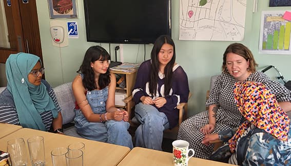 Students chatting with a School Court resident