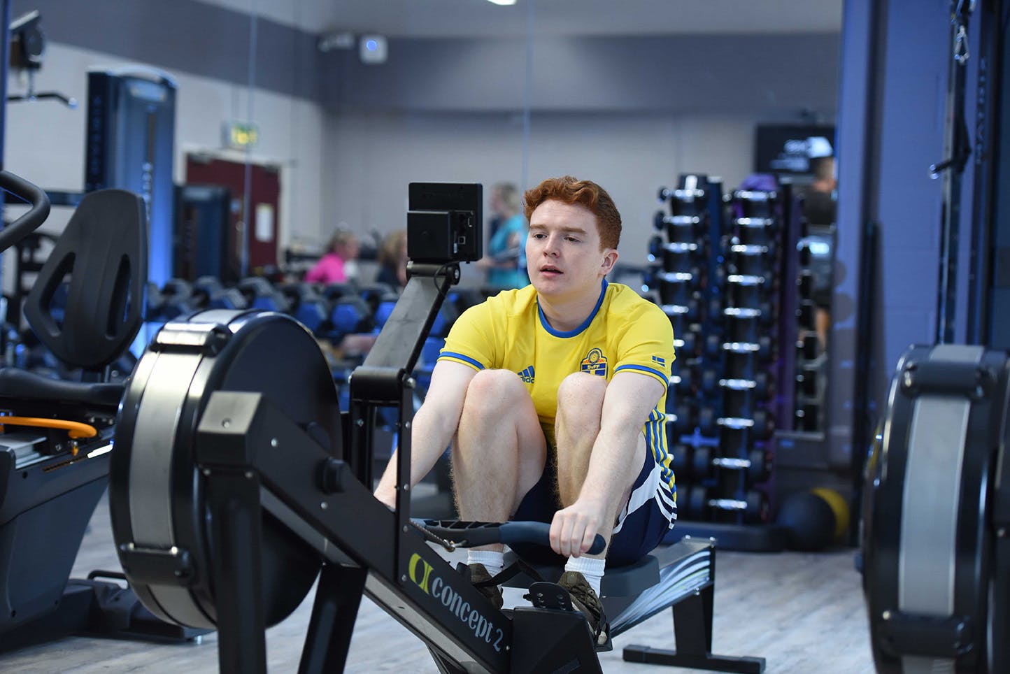 Student on the rowing machine in the gym