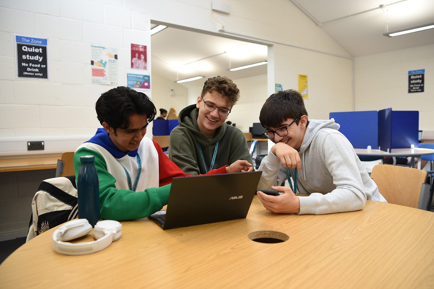 three students with laptop in the Zone