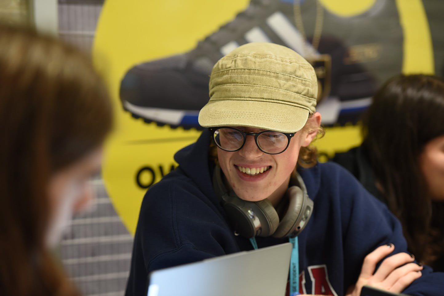 Student wearing hat and headphones