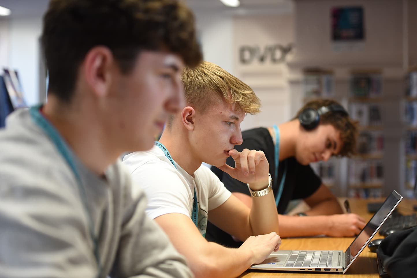 Three students working in the library