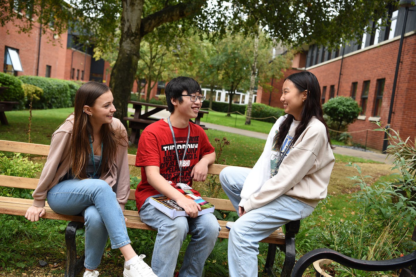 Three students relaxing outside