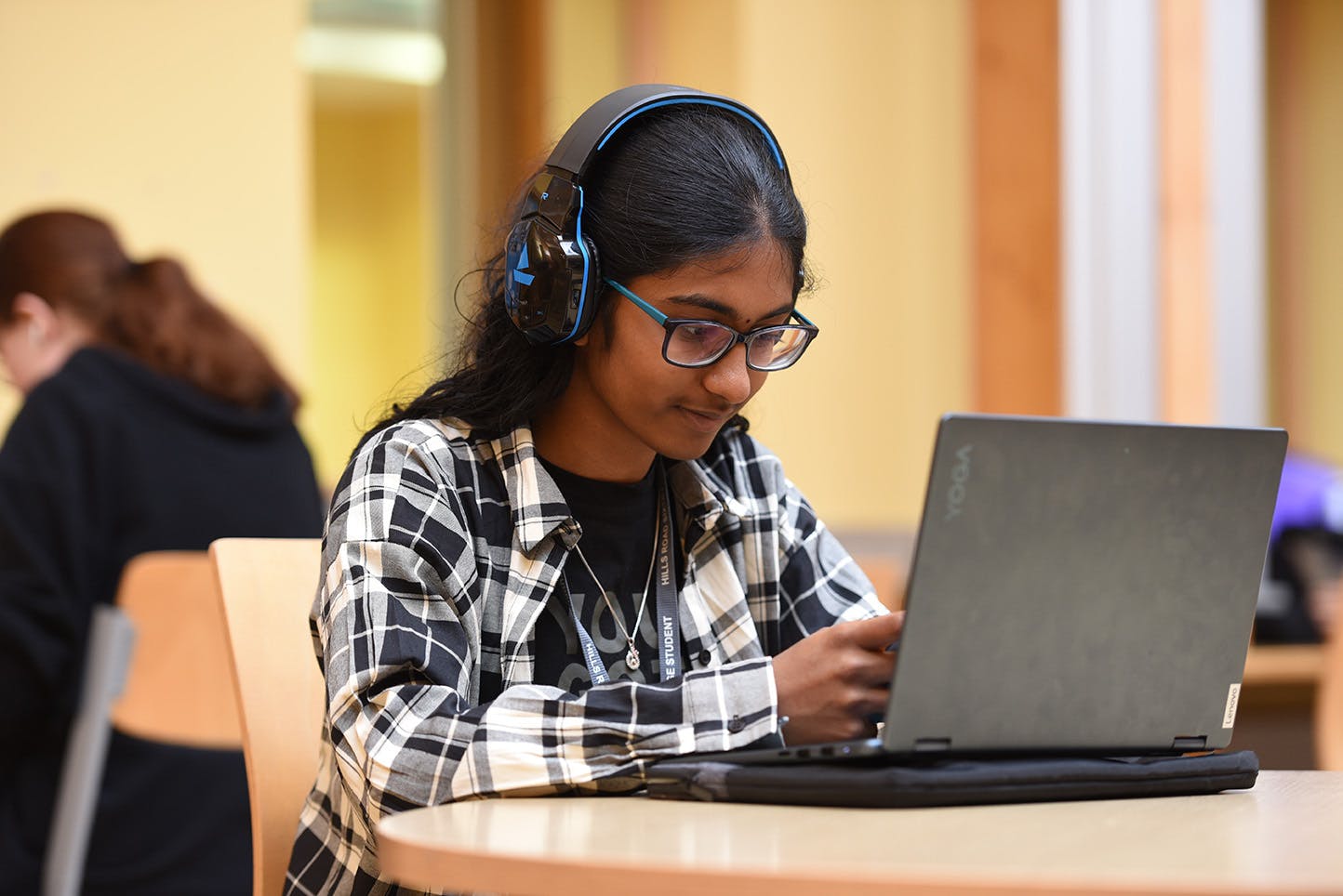 Student wearing headphones in front of laptop