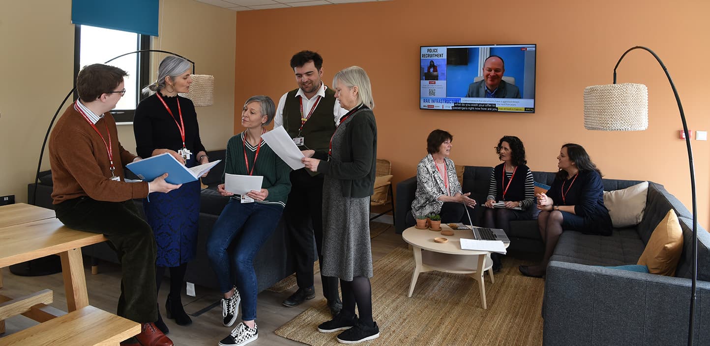 Groups of staff talking in the staff room