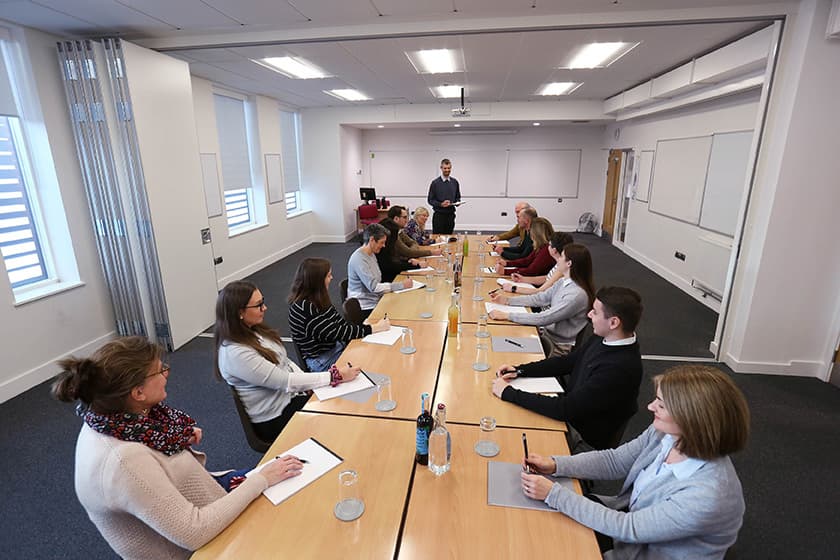 People sitting around a table in the seminar room