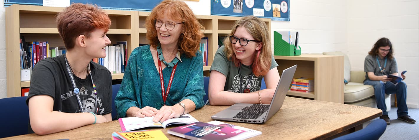 Students talking with a member of staff