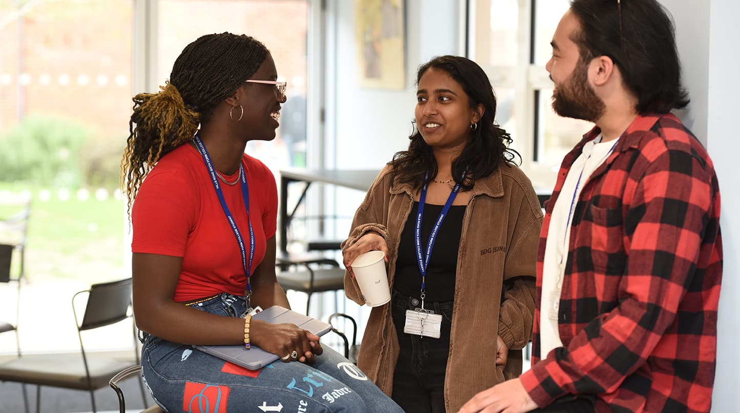 Three students talking in cafe
