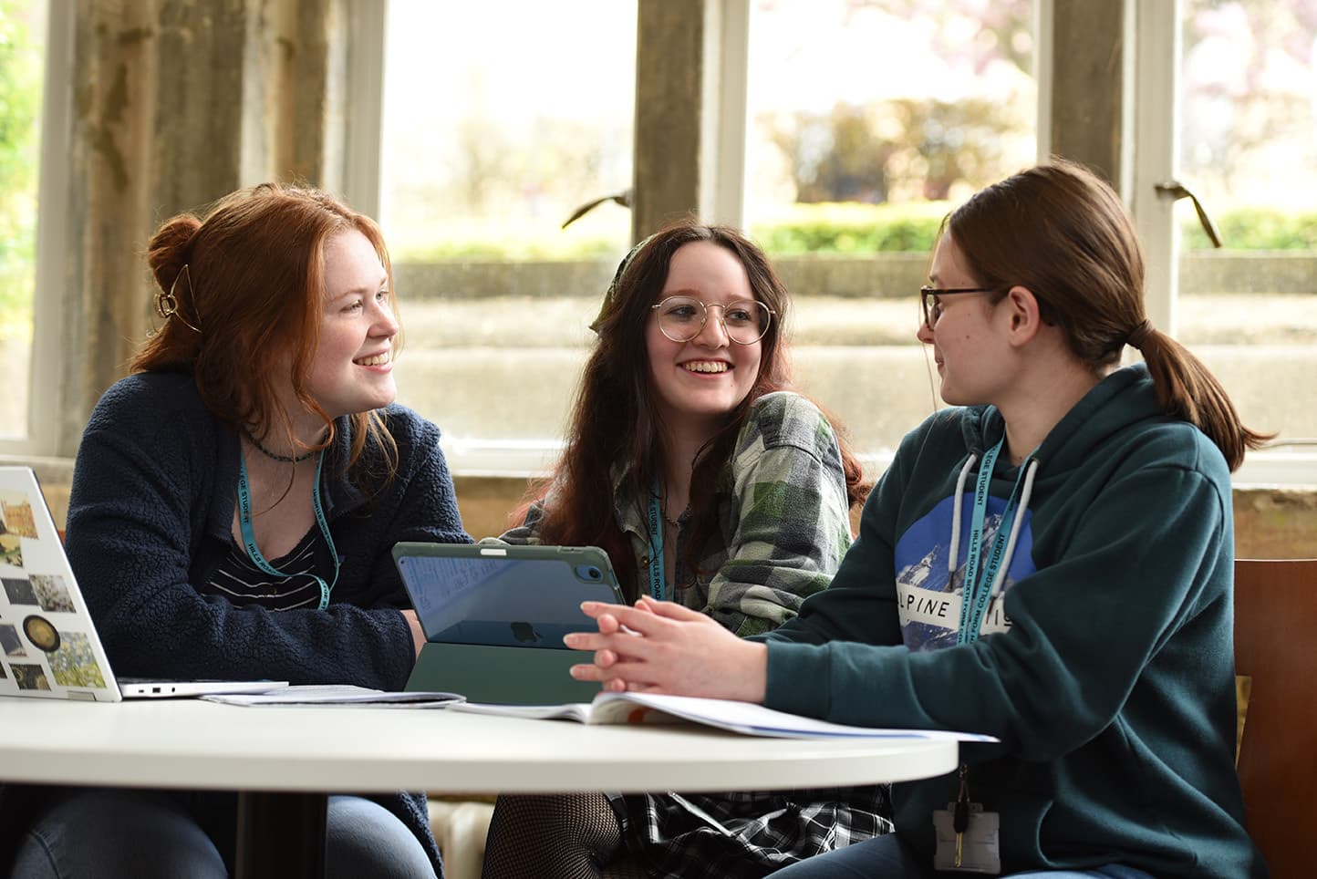 three students socialising in the hub